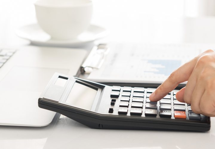 closeup hands on calculator