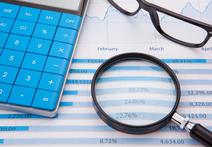 Calculator, pen and business balance