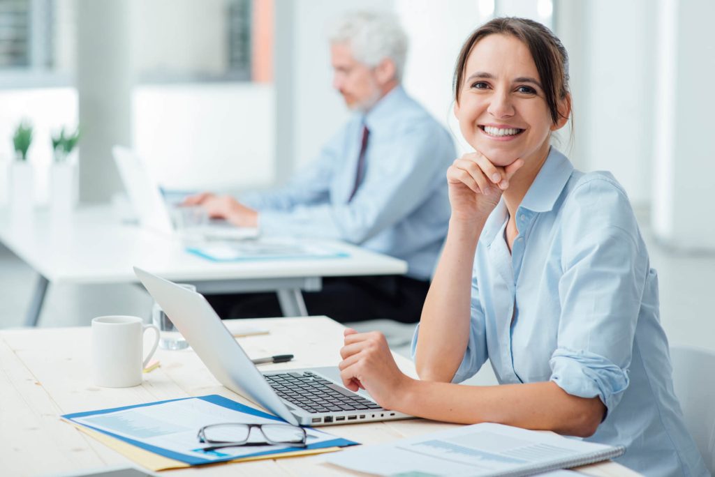 smiling female business head working on independent contractor management processes